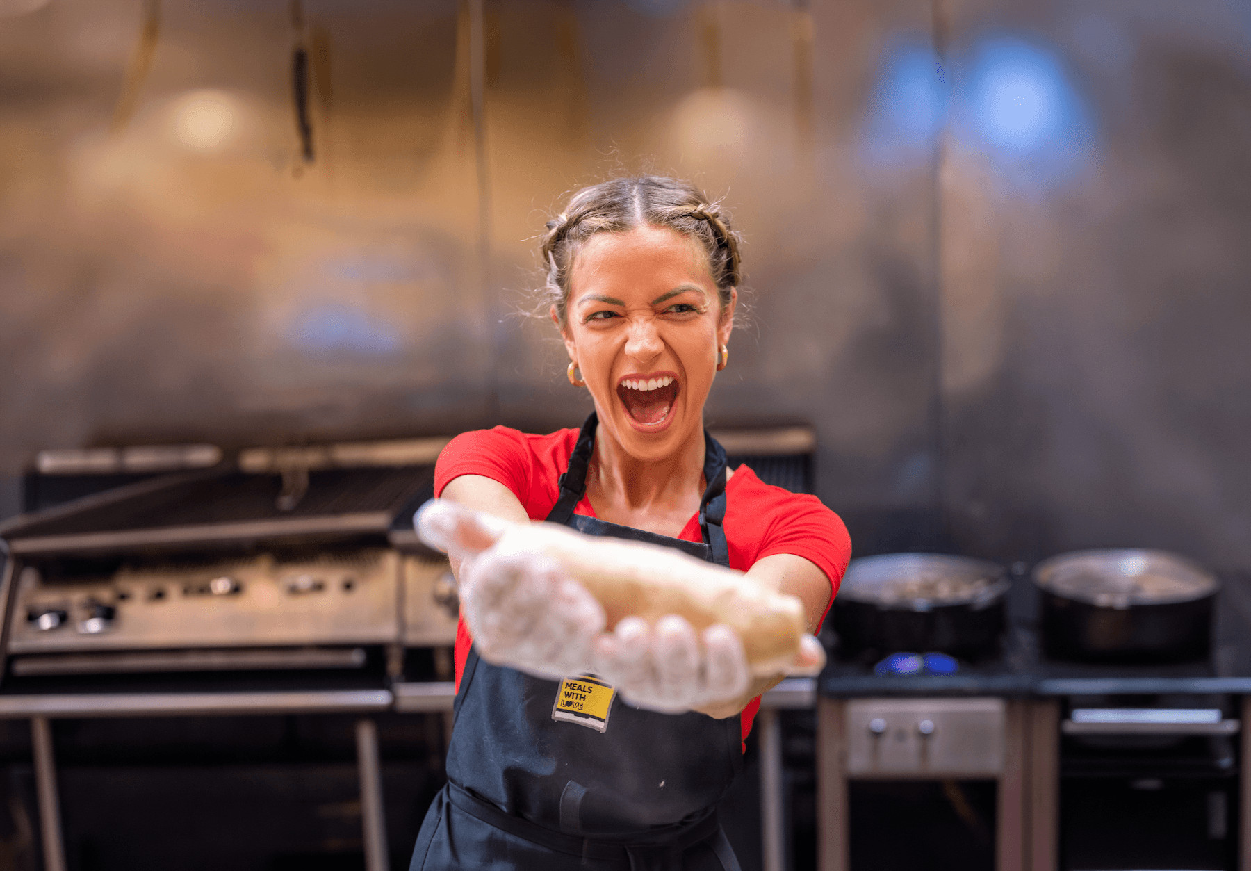 Action shot of an Anna's Taqueria Charity Roller rolling a burrito for customers