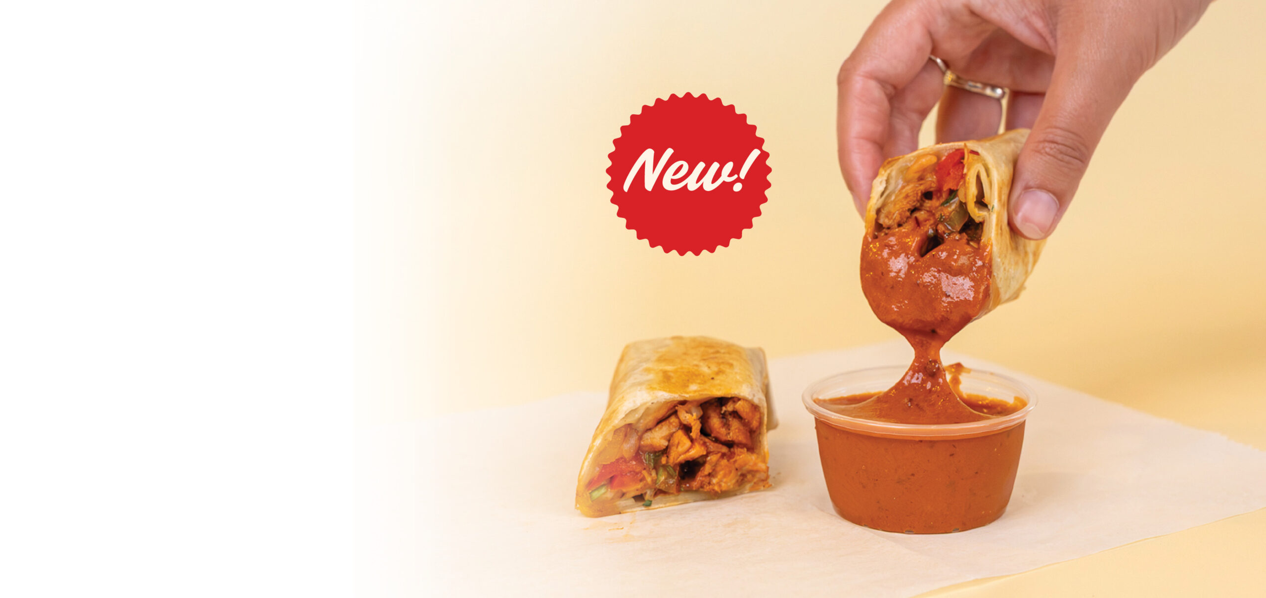 Anna's Taqueria Chipotle Chicken Taquito dipped in chipotle sauce