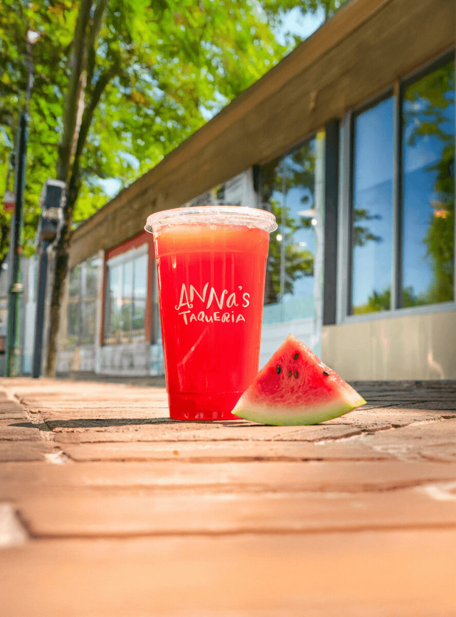 Anna's Taqueria Agua Fresca beverage with watermelon slice