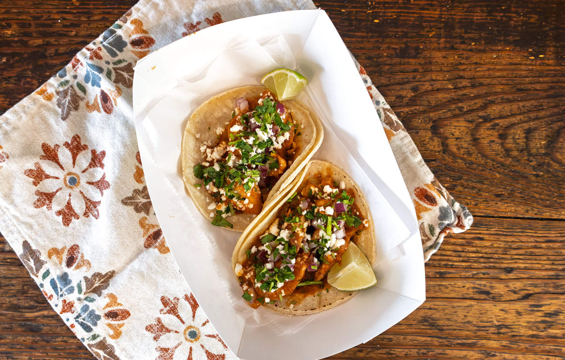 Anna's Taqueria chicken tinga tacos topped with red onion, queso fresco and cilantro